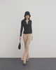 she is wearing a black bustier ribbed T-shirt, Chanel Choker as a necklace, and ribbed flared leggings in beige colour